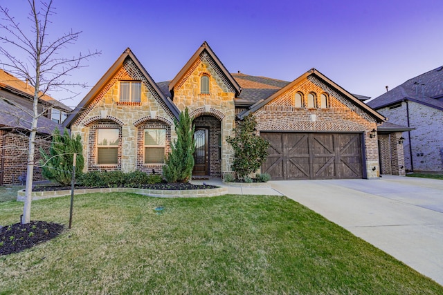 tudor house with a garage and a yard