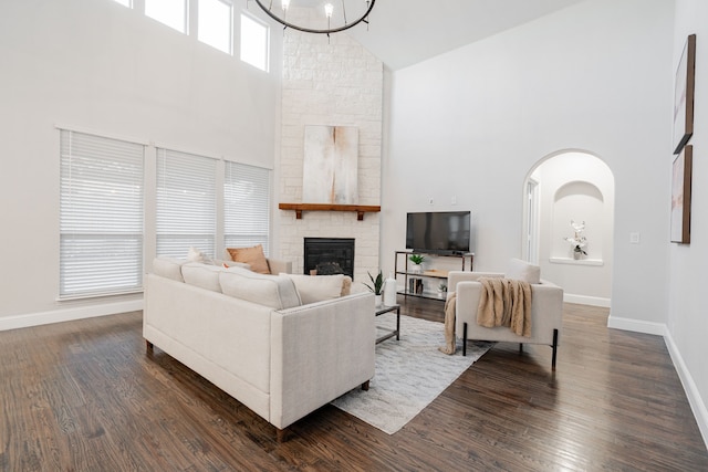 1108 Canterbury Ln, Forney, TX 75126 - living area with high vaulted ceiling, a fireplace, dark wood-type flooring, and arched walkways