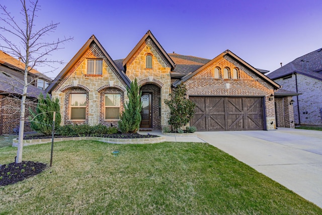 1108 Canterbury Ln, Forney, TX 75126 - view of front of property with brick siding, concrete driveway, a front lawn, an attached garage, and stone siding