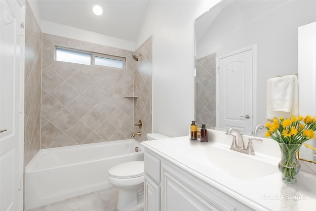 full bathroom featuring vanity, tiled shower / bath combo, tile patterned floors, and toilet