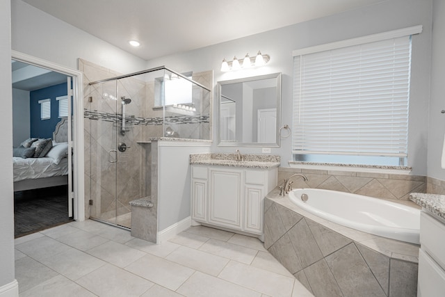 bathroom featuring vanity, independent shower and bath, and tile patterned flooring