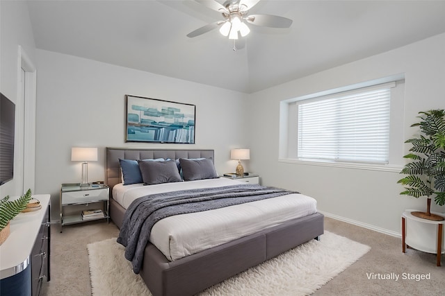 bedroom with light carpet, lofted ceiling, and ceiling fan