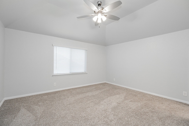 spare room featuring lofted ceiling, carpet flooring, and ceiling fan