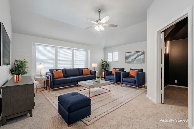 living room with vaulted ceiling, light colored carpet, and ceiling fan