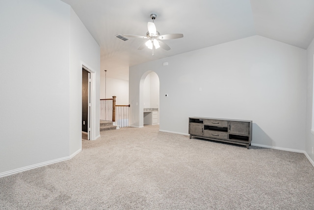 spare room featuring ceiling fan, vaulted ceiling, and light carpet