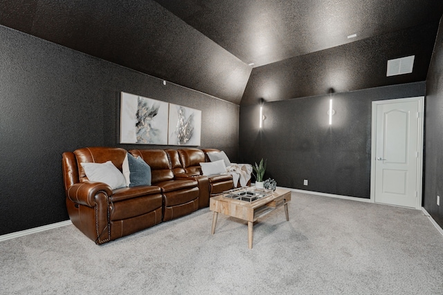 carpeted cinema room featuring vaulted ceiling