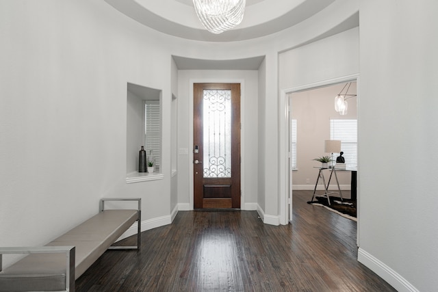 foyer entrance featuring dark wood-type flooring and a notable chandelier