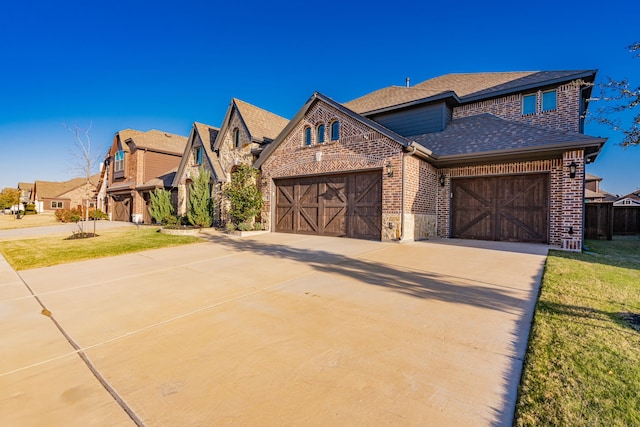 1108 Canterbury Ln, Forney, TX 75126 - view of front of property featuring brick siding, a shingled roof, an attached garage, concrete driveway, and a front yard