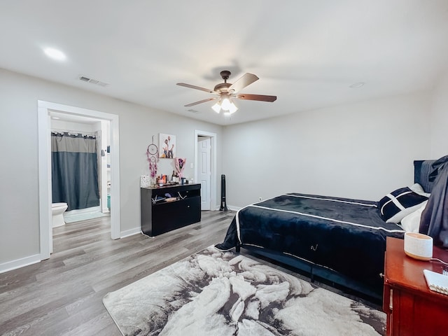 bedroom with connected bathroom, ceiling fan, and light wood-type flooring