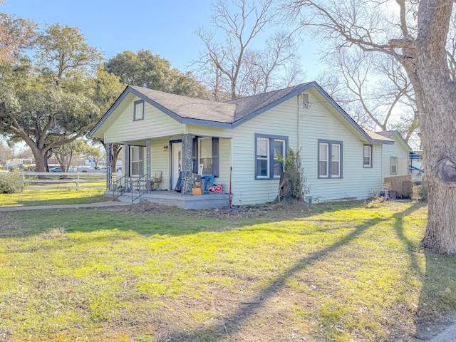 view of front of house with a porch and a front yard