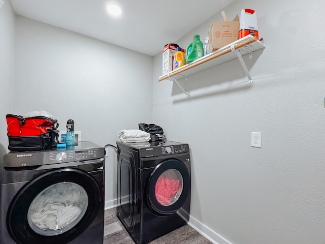 washroom featuring washer and dryer and light hardwood / wood-style floors