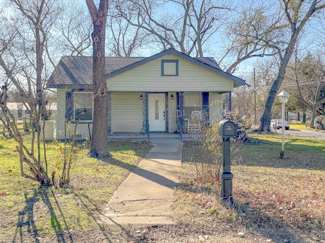 view of front of property with a porch and a front lawn