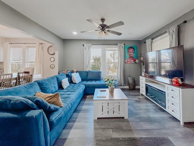 living room with dark hardwood / wood-style floors and ceiling fan