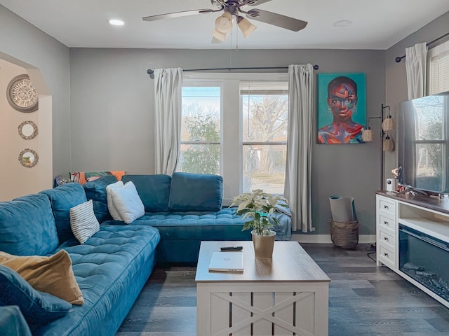 living room featuring dark hardwood / wood-style flooring and ceiling fan