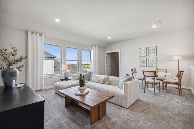 carpeted living room with lofted ceiling