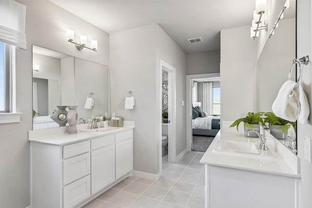 bathroom featuring vanity, toilet, and tile patterned flooring