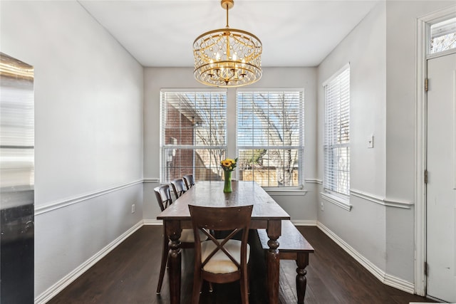 dining area with an inviting chandelier, dark wood-type flooring, and a wealth of natural light