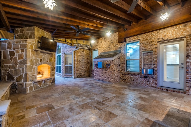 view of patio / terrace with ceiling fan and an outdoor stone fireplace