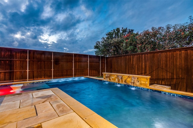 view of pool with pool water feature and a patio area