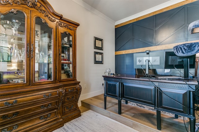 office area with crown molding and light hardwood / wood-style flooring