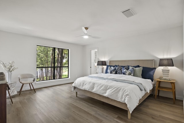 bedroom with dark wood-type flooring and ceiling fan