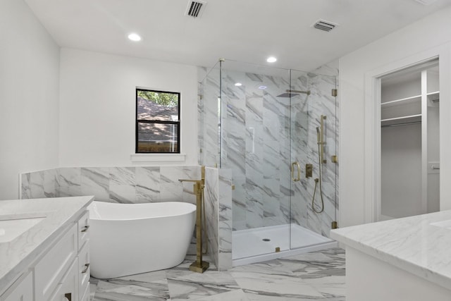 bathroom featuring plus walk in shower, tile walls, and vanity