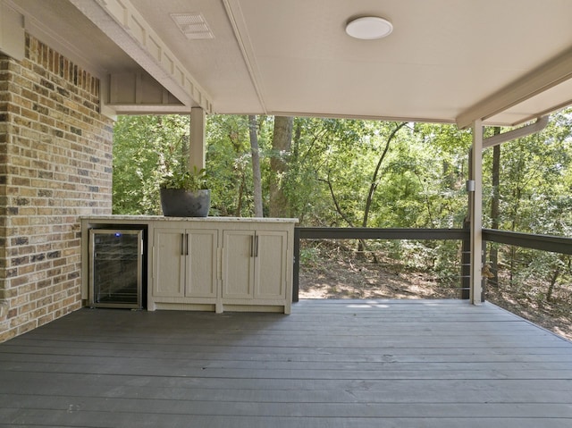 wooden terrace featuring beverage cooler