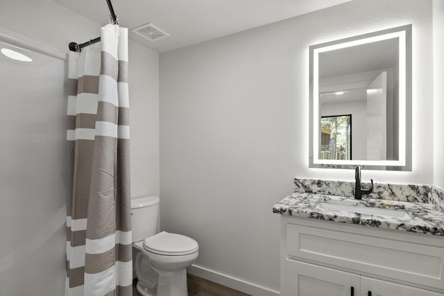 bathroom with vanity, curtained shower, wood-type flooring, and toilet