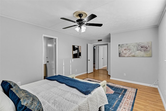 bedroom with wood-type flooring, ornamental molding, and ceiling fan