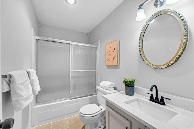 full bathroom with vanity, toilet, tile patterned flooring, and combined bath / shower with glass door