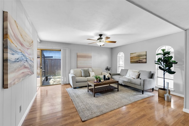 living room featuring ceiling fan and light hardwood / wood-style floors