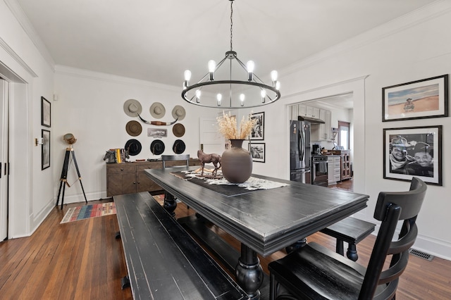 dining area featuring an inviting chandelier, crown molding, and dark hardwood / wood-style floors