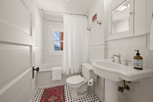 bathroom with toilet, tile patterned flooring, and shower / bath combo with shower curtain