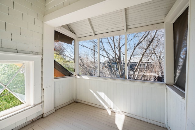 unfurnished sunroom featuring lofted ceiling