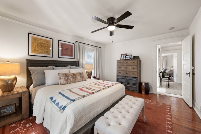 bedroom featuring dark hardwood / wood-style flooring, crown molding, and ceiling fan