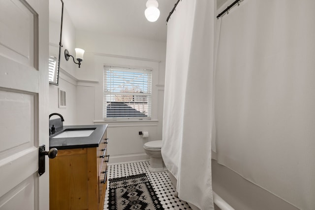 full bathroom featuring vanity, shower / tub combo with curtain, and toilet