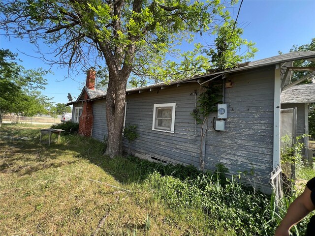 view of side of home featuring a lawn