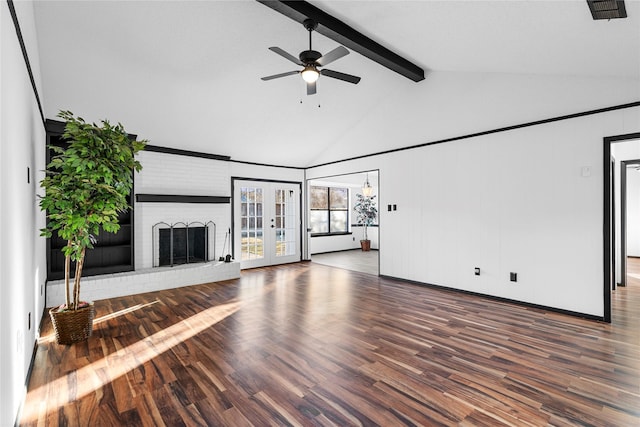 unfurnished living room with ceiling fan, dark hardwood / wood-style floors, a fireplace, lofted ceiling with beams, and french doors