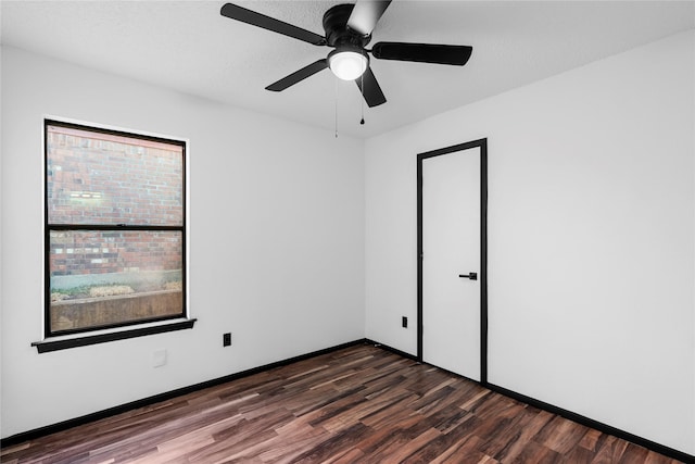 unfurnished room with dark hardwood / wood-style flooring and a textured ceiling