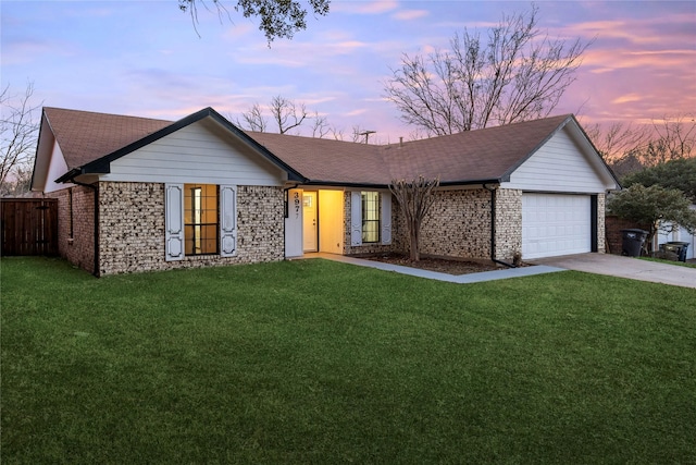 ranch-style home with a garage and a lawn