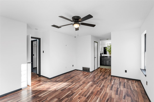 unfurnished room featuring ceiling fan and dark hardwood / wood-style flooring