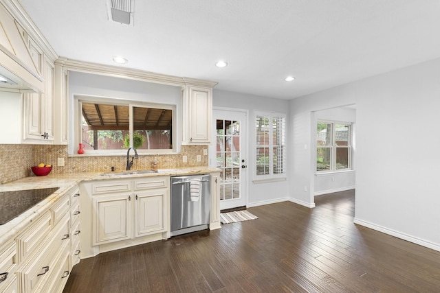 kitchen with a wealth of natural light, sink, stainless steel dishwasher, and cream cabinetry