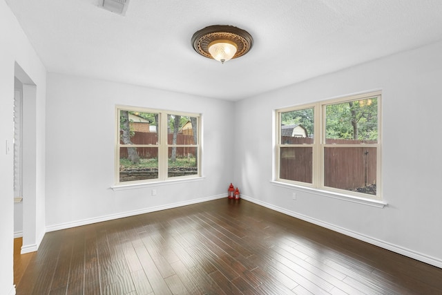 spare room featuring dark hardwood / wood-style flooring