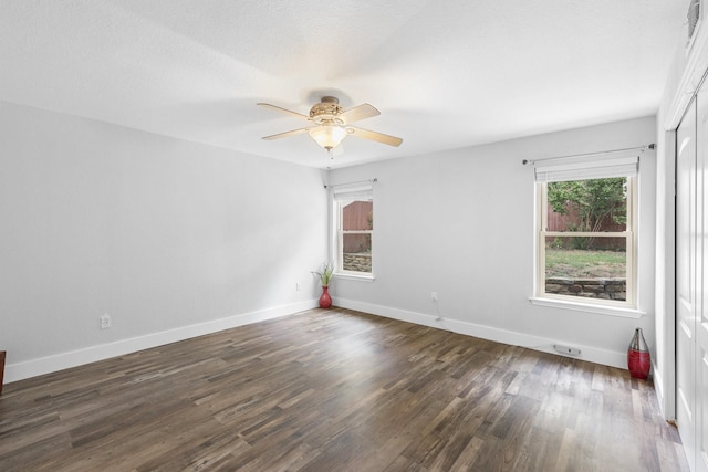 unfurnished room featuring dark hardwood / wood-style floors and ceiling fan