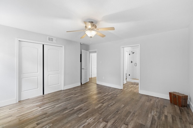 unfurnished bedroom featuring ceiling fan, dark hardwood / wood-style flooring, and a closet