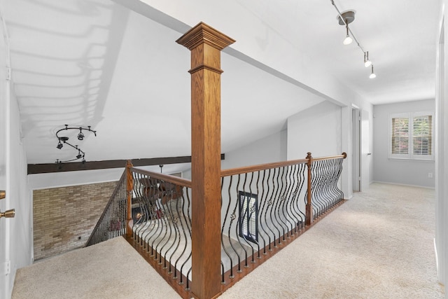 hall featuring light colored carpet and lofted ceiling