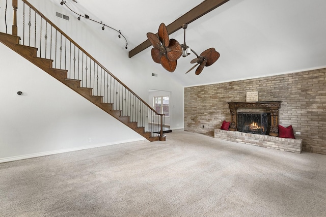 unfurnished living room featuring beamed ceiling, a brick fireplace, carpet flooring, and high vaulted ceiling