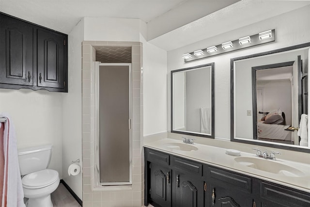 bathroom featuring vanity, toilet, and walk in shower