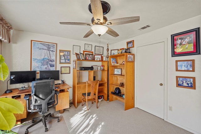 carpeted office with ceiling fan