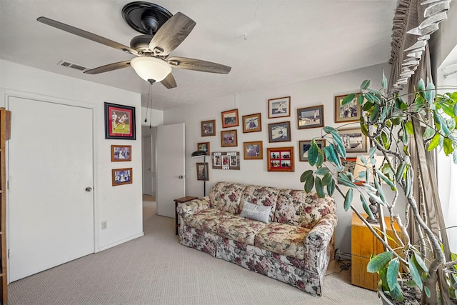 living room featuring light colored carpet and ceiling fan